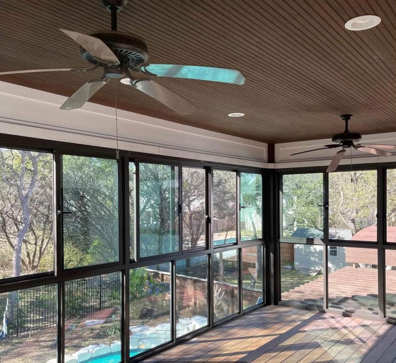 Finished screened porch with wood ceiling and ceiling fans