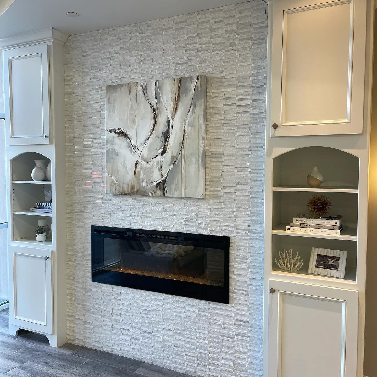 Fireplace wall with stone tile, built-ins and finished carpentry