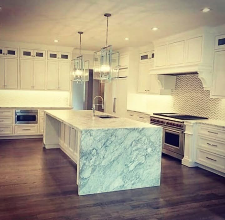 Bright white kitchen remodel with large island and finished cabinetry