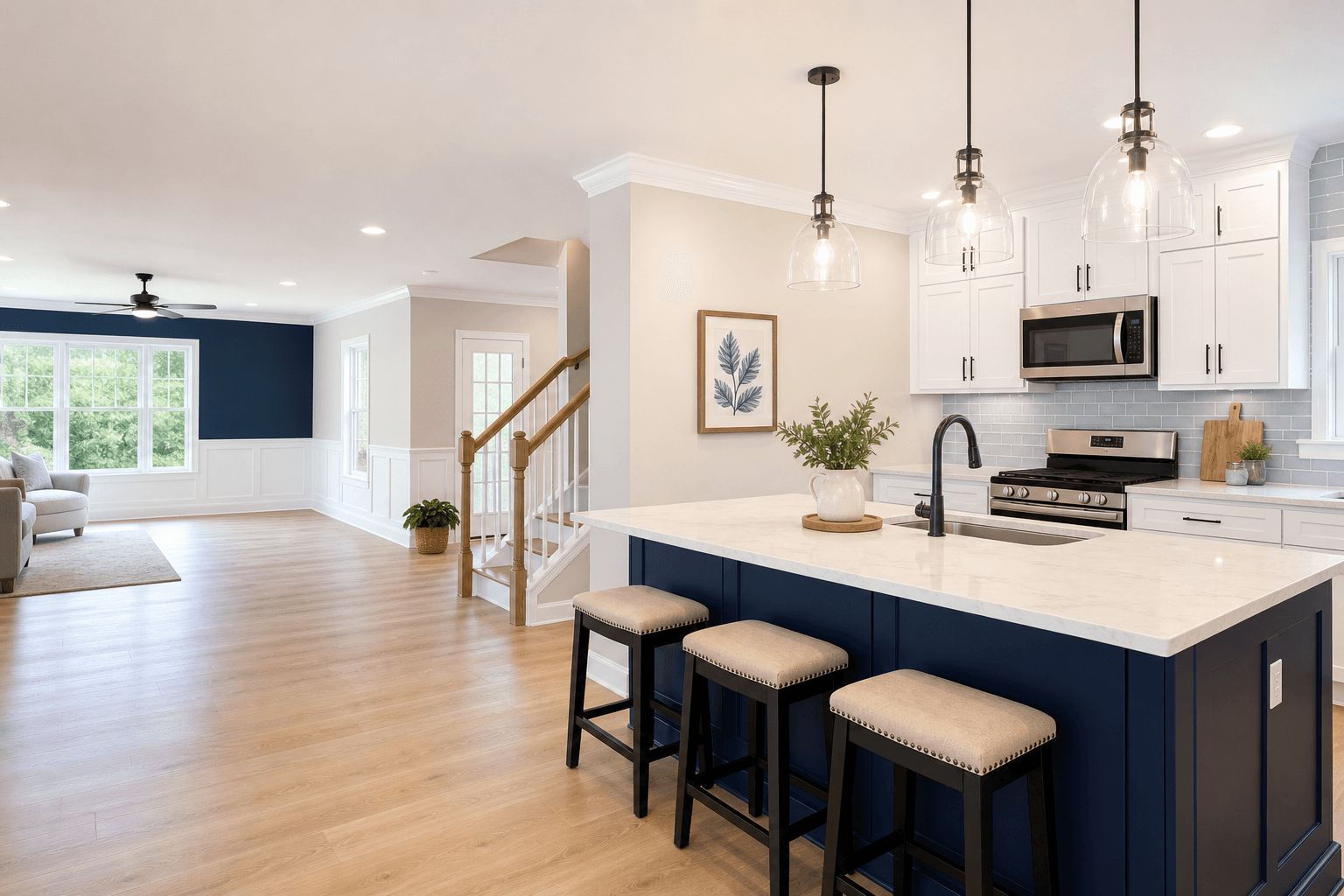 Freshly remodeled kitchen and living area with navy accents, new paint, trim and flooring